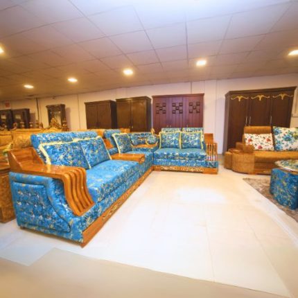 A stylish blue and gold sofa decorated with a unique gold and blue pattern, adding a touch of stylishness to any space.
