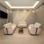 Modern minimalist living room with a stylish beige 3-piece sofa set featuring brown accents, placed on a wooden floor with a geometric-patterned accent wall and a mounted flat-screen TV.