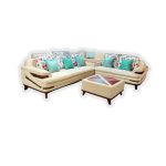 “Modern modular corner sofa set in a bright living room with beige upholstery, colorful floral and teal accent pillows, matching ottoman and natural sunlight streaming through large windows”