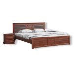 "Elegant wooden bed with decorative headboard and footboard, paired with matching bedside table, placed in a modern bedroom with wooden flooring and natural light."