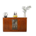 Elegant wooden sideboard cabinet with two paneled doors, one glass-front middle section displaying glassware, and a smooth polished finish, placed in a modern dining room interior.