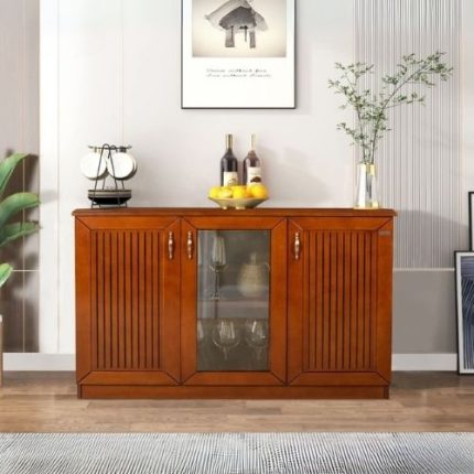 Elegant wooden sideboard cabinet with two paneled doors, one glass-front middle section displaying glassware, and a smooth polished finish, placed in a modern dining room interior.