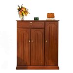 "Wooden storage cabinet placed under staircase, decorated with flower vase, digital clock, and fine wines box in a modern home interior."