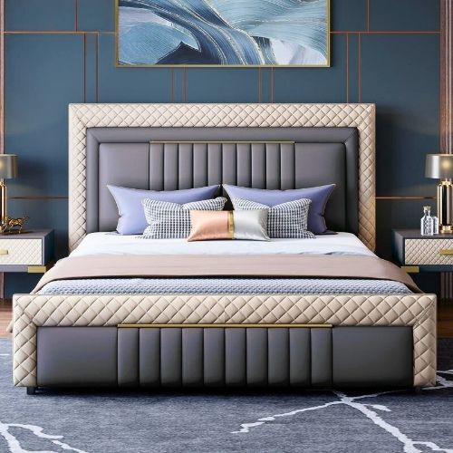 Standard Godi Bed Elegant modern upholstered bed with beige padding and gold wooden frame in a stylish bedroom with sunburst mirror, bedside lamp, and floor-to-ceiling curtains.