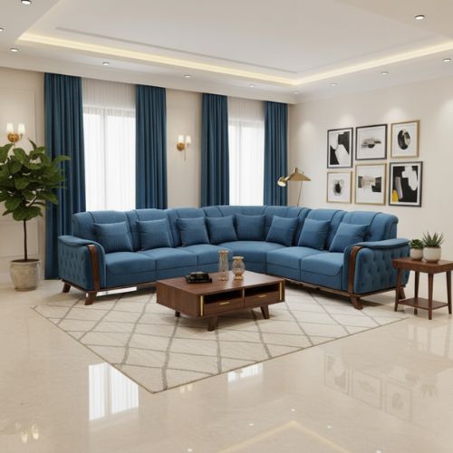 Minimalist Corner Sofa Modern living room featuring a large L-shaped blue fabric sectional sofa with wooden accents, set on a cream geometric rug. The room includes a wooden coffee table, side table with a plant, framed wall art, tall windows with blue curtains, and soft ambient lighting creating a cozy, elegant atmosphere.