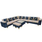 Luxurious L-shaped sectional sofa in blue and beige velvet upholstery, featuring gold metal legs and matching ottomans, set in a modern living room with bright lighting and elegant décor.